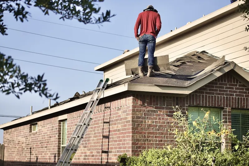 Professional roofer working on a residential roof in Paul A Diggs